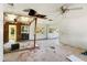 A Living Room in poor condition with debris and exposed ceiling and walls at 2677 Martin St, Sarasota, FL 34237