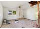 A Living Room in poor condition with debris and exposed ceiling and walls at 2677 Martin St, Sarasota, FL 34237