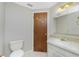 Bathroom showcasing a neutral vanity with a mirror and adjacent toilet at 2690 Auburn Blvd, Port Charlotte, FL 33948