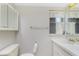 Bathroom features a white vanity, mirror, and natural light from a window at 2690 Auburn Blvd, Port Charlotte, FL 33948