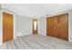 Bedroom with wood-style flooring, neutral paint, and standard wooden doors at 2690 Auburn Blvd, Port Charlotte, FL 33948