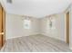 Spacious bedroom with two windows, light wood-style flooring, and neutral paint at 2690 Auburn Blvd, Port Charlotte, FL 33948