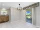 Bright dining area with tiled flooring and view of the lanai at 2690 Auburn Blvd, Port Charlotte, FL 33948