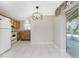 Dining area featuring updated lighting fixture and access to the screened in lanai at 2690 Auburn Blvd, Port Charlotte, FL 33948