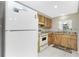 Cozy kitchen with wood cabinets, granite countertops, and bright natural light from the window at 2690 Auburn Blvd, Port Charlotte, FL 33948