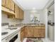 Efficient kitchen with light wood cabinets, stone countertops and an adjacent laundry area at 2690 Auburn Blvd, Port Charlotte, FL 33948