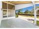 The screened lanai offers relaxation with a peaceful outdoor view of sky and trees at 2690 Auburn Blvd, Port Charlotte, FL 33948