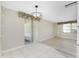 Bright and open living area with tile and wood flooring, sliding glass door, and contemporary lighting at 2690 Auburn Blvd, Port Charlotte, FL 33948