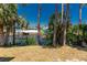 View of a waterway, docks, and waterfront homes amid lush trees under a clear blue sky at 2690 Auburn Blvd, Port Charlotte, FL 33948