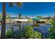 View of a waterway, docks, and waterfront homes amid lush trees under a clear blue sky at 2690 Auburn Blvd, Port Charlotte, FL 33948