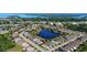 Beautiful aerial view of the community with a lake and well-maintained homes near the water and green spaces at 28059 Arrowhead Cir, Punta Gorda, FL 33982