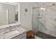 Modern bathroom showcases a sleek glass shower with pebble floor, granite countertop, and stylish, neutral decor at 28059 Arrowhead Cir, Punta Gorda, FL 33982