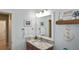 Charming bathroom featuring a granite countertop, decorative nautical elements, and a bright, inviting ambiance at 28059 Arrowhead Cir, Punta Gorda, FL 33982