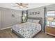 Bright bedroom with blue accents, light-colored walls, and a view of the outside at 28059 Arrowhead Cir, Punta Gorda, FL 33982
