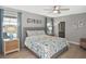 Charming bedroom with a ceiling fan, blue accents, and an ensuite bathroom at 28059 Arrowhead Cir, Punta Gorda, FL 33982