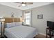 Cozy bedroom features a ceiling fan, side table and beach-themed decor at 28059 Arrowhead Cir, Punta Gorda, FL 33982
