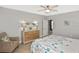 Bedroom with light walls, light wood floors, and a neutral-colored chair at 28059 Arrowhead Cir, Punta Gorda, FL 33982