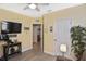 Exercise room with ceiling fan, nautical decor, and access to the ensuite bathroom at 28059 Arrowhead Cir, Punta Gorda, FL 33982