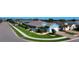 Well-maintained blue home with lush landscaping, palm trees, and a neatly manicured lawn on a sunny day at 28059 Arrowhead Cir, Punta Gorda, FL 33982