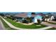 Charming blue home featuring a vibrant green lawn and mature palm trees along a street at 28059 Arrowhead Cir, Punta Gorda, FL 33982