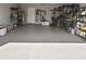 Large, organized garage with epoxy flooring, ample storage, and various tools and equipment neatly arranged at 28059 Arrowhead Cir, Punta Gorda, FL 33982