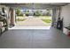 Spacious garage opening to a long brick driveway with a view of the neighborhood homes at 28059 Arrowhead Cir, Punta Gorda, FL 33982
