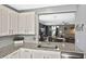 Well-lit kitchen featuring granite countertops, white cabinets, and stainless steel appliances at 28059 Arrowhead Cir, Punta Gorda, FL 33982