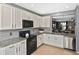 Well-lit kitchen featuring granite countertops, white cabinets, and stainless steel appliances at 28059 Arrowhead Cir, Punta Gorda, FL 33982