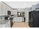 Bright kitchen featuring granite countertops, stainless steel appliances, and white cabinets at 28059 Arrowhead Cir, Punta Gorda, FL 33982