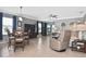 Open-concept living room with dining area, providing ample space and natural light from the view of the lanai at 28059 Arrowhead Cir, Punta Gorda, FL 33982