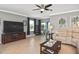 Bright and airy living room with a media center and view to the screened in lanai via sliding glass doors at 28059 Arrowhead Cir, Punta Gorda, FL 33982