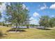 Scenic view of a serene pond surrounded by lush greenery and blue skies, creating a peaceful atmosphere at 28059 Arrowhead Cir, Punta Gorda, FL 33982