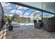 Inviting screened-in pool area featuring a pool, lounge chairs, and comfortable seating for outdoor relaxation at 28059 Arrowhead Cir, Punta Gorda, FL 33982
