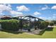 Backyard pool view with screened enclosure and privacy landscaping at 28059 Arrowhead Cir, Punta Gorda, FL 33982