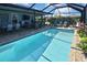 Inviting screened pool with outdoor seating and tropical landscaping at 28059 Arrowhead Cir, Punta Gorda, FL 33982