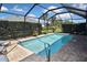 Relaxing screened pool with brick pavers and tropical landscaping at 28059 Arrowhead Cir, Punta Gorda, FL 33982