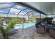 Relaxing screened pool with brick pavers, chairs, and dining area at 28059 Arrowhead Cir, Punta Gorda, FL 33982