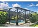 Relaxing screened-in pool area with lush landscaping, ideal for outdoor entertaining and enjoying the beautiful weather at 28059 Arrowhead Cir, Punta Gorda, FL 33982