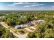 Aerial view of the home with a spacious backyard and a lush green landscape at 2903 Pope St, North Port, FL 34287