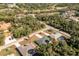 An aerial view of a home nestled among lush greenery and mature trees in a desirable neighborhood at 2903 Pope St, North Port, FL 34287