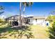 Manicured backyard features a pool enclosed with a screen for enjoyment and privacy at 2903 Pope St, North Port, FL 34287