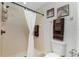 Bathroom featuring a tiled shower, toilet, and decorative nautical artwork and warm colored towels at 2903 Pope St, North Port, FL 34287
