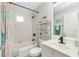 Clean bathroom with a shower-tub combo, toilet, and sink with a mirror at 2903 Pope St, North Port, FL 34287