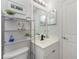 Modern bathroom featuring a sink, toilet, shelving, and a mirror at 2903 Pope St, North Port, FL 34287