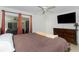 Bright and airy bedroom with a ceiling fan, a large dresser, and a glass sliding door that opens to a screened porch at 2903 Pope St, North Port, FL 34287