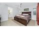 Spacious bedroom featuring a ceiling fan, an attached bathroom, and natural light at 2903 Pope St, North Port, FL 34287