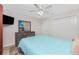 Cozy bedroom featuring a ceiling fan, a dresser, and a closet at 2903 Pope St, North Port, FL 34287