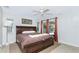Comfortable bedroom featuring a ceiling fan, warm brown color scheme, and sliding glass doors to the pool area at 2903 Pope St, North Port, FL 34287