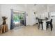 Dining area with patio access, adjacent to kitchen with white cabinetry at 2903 Pope St, North Port, FL 34287
