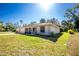 Well-maintained single-story home with manicured lawn, attached garage, and an inviting front porch with decorative columns at 2903 Pope St, North Port, FL 34287
